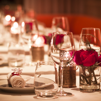 Couple toasting champagne flutes in restaurant 